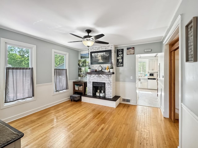 307 Christie St, Ottawa, IL 61350 - living room featuring a fireplace, light wood-type flooring, and ceiling fan