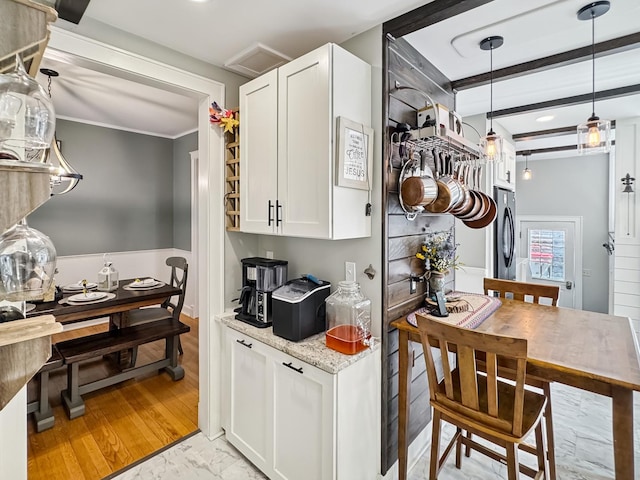 307 Christie St, Ottawa, IL 61350 - kitchen with white cabinets, light stone counters, crown molding, and hanging light fixtures