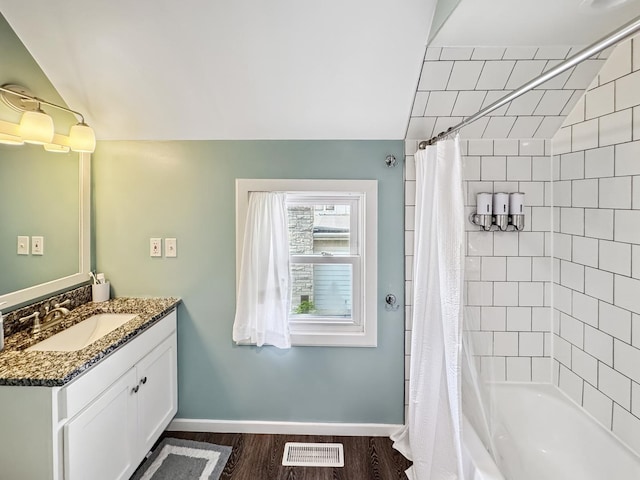 307 Christie St, Ottawa, IL 61350 - full bath with vanity, shower / tub combo, wood finished floors, and vaulted ceiling