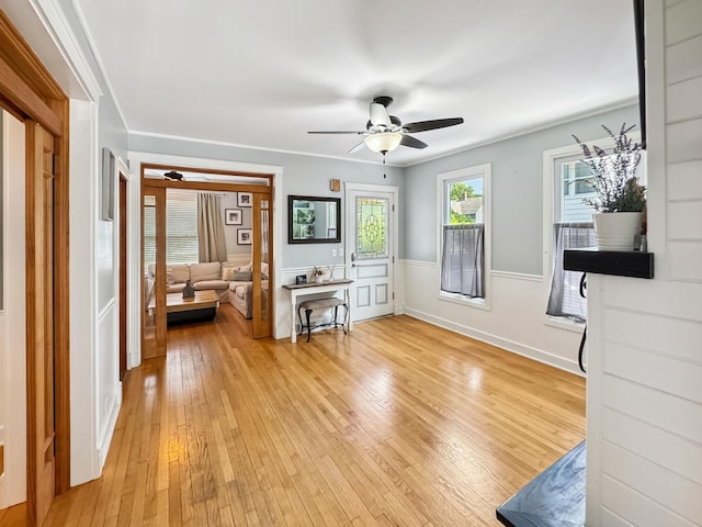 307 Christie St, Ottawa, IL 61350 - living area featuring ceiling fan, light wood-style floors, and a wainscoted wall