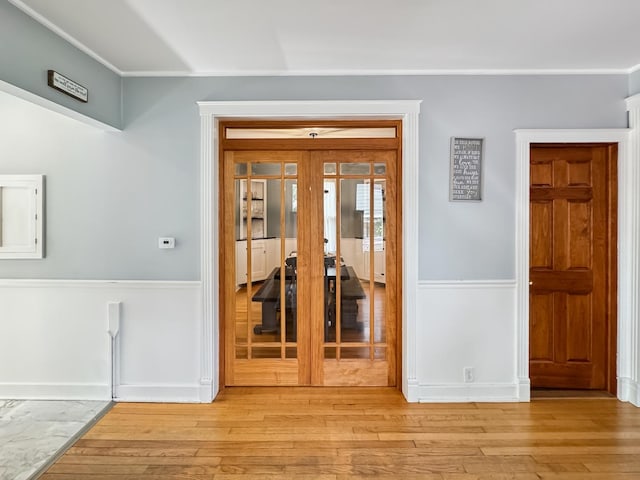 307 Christie St, Ottawa, IL 61350 - spare room featuring a wainscoted wall, light wood-style floors, french doors, and ornamental molding