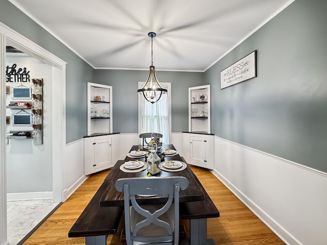307 Christie St, Ottawa, IL 61350 - dining space with crown molding, a wainscoted wall, and light wood-style flooring