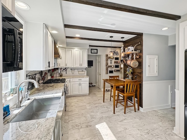 307 Christie St, Ottawa, IL 61350 - kitchen featuring white cabinets, beamed ceiling, wall chimney range hood, tasteful backsplash, and light stone countertops