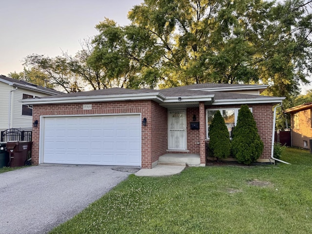 17303 Kedzie Ave, Hazel Crest, IL 60429 - view of front of home with brick siding, driveway, a front yard, and a garage