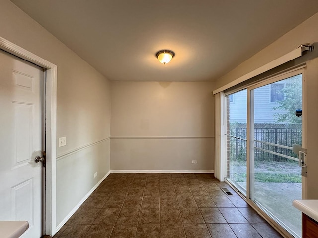 17303 Kedzie Ave, Hazel Crest, IL 60429 - empty room with healthy amount of natural light and dark tile patterned flooring