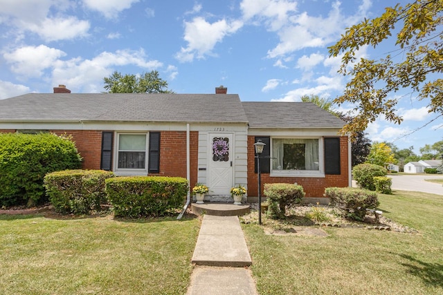 1723 N Raynor Ave, Crest Hill, IL 60403 - view of front of home with brick siding, a front lawn, and a chimney
