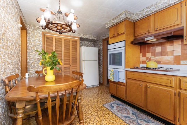 1723 N Raynor Ave, Crest Hill, IL 60403 - kitchen with white appliances, a chandelier, light countertops, brown cabinets, and tasteful backsplash
