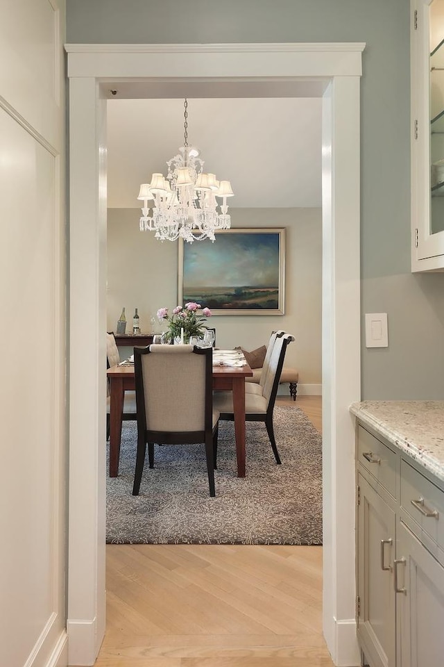 100 Beach Rd, Glencoe, IL 60022 - dining space with light wood-type flooring and a chandelier
