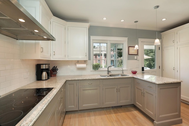 100 Beach Rd, Glencoe, IL 60022 - kitchen featuring ventilation hood, black electric stovetop, a peninsula, healthy amount of natural light, and crown molding