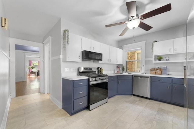 317 N Marion St, Oak Park, IL 60302 - kitchen with stainless steel appliances, blue cabinetry, ceiling fan, light countertops, and white cabinetry