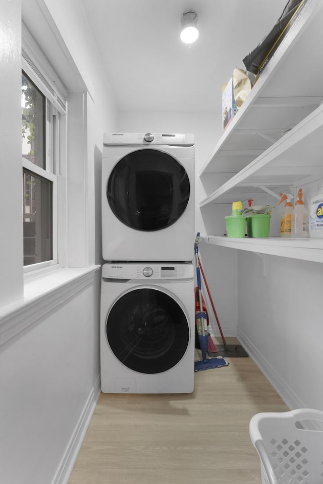 317 N Marion St, Oak Park, IL 60302 - laundry room featuring estacked washer and dryer and wood finished floors
