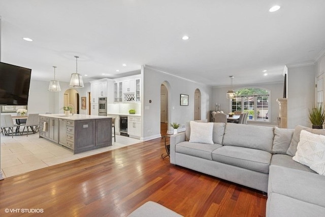 3967 Garden Ave, Western Springs, IL 60558 - living room with arched walkways, ornamental molding, beverage cooler, recessed lighting, and light wood-style flooring