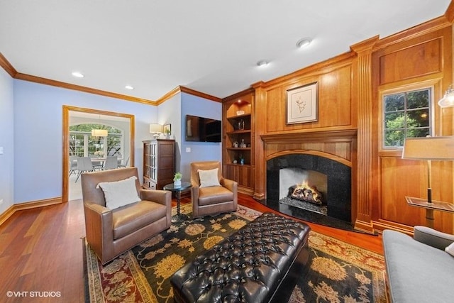 3967 Garden Ave, Western Springs, IL 60558 - living area featuring wood finished floors, ornamental molding, a premium fireplace, built in features, and recessed lighting
