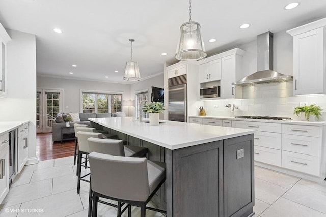 3967 Garden Ave, Western Springs, IL 60558 - kitchen featuring wall chimney exhaust hood, stainless steel appliances, open floor plan, white cabinetry, and recessed lighting