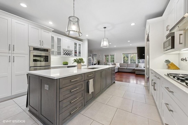 3967 Garden Ave, Western Springs, IL 60558 - kitchen with stainless steel appliances, white cabinetry, open floor plan, recessed lighting, and light countertops