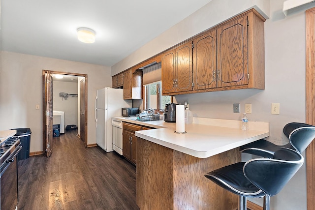 831 Horseshoe Dr Unit B, Joliet, IL 60435 - kitchen featuring black appliances, a peninsula, dark wood-style floors, light countertops, and brown cabinets