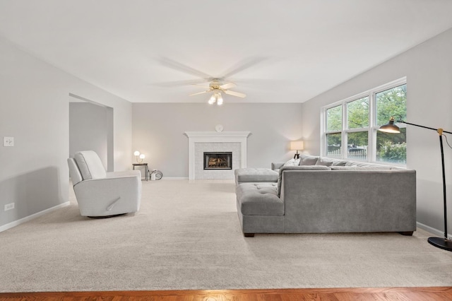 2311 Tremont Ave, Aurora, IL 60502 - living room with a ceiling fan, a tile fireplace, and light carpet