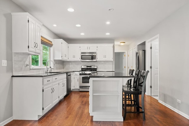 2311 Tremont Ave, Aurora, IL 60502 - kitchen featuring appliances with stainless steel finishes, white cabinets, dark countertops, and recessed lighting