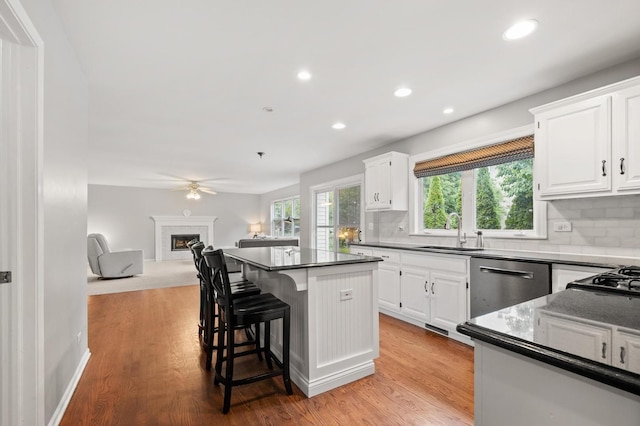 2311 Tremont Ave, Aurora, IL 60502 - kitchen featuring dishwasher, dark countertops, white cabinets, ceiling fan, and recessed lighting