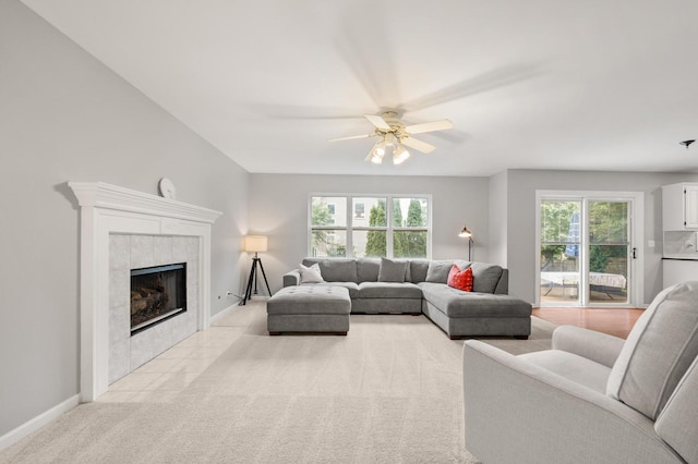 2311 Tremont Ave, Aurora, IL 60502 - living room featuring healthy amount of natural light, a tile fireplace, ceiling fan, and light carpet