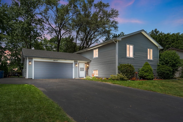 3850 Seaview Dr, Hanover Park, IL 60133 - view of front of property featuring driveway, an attached garage, and a lawn
