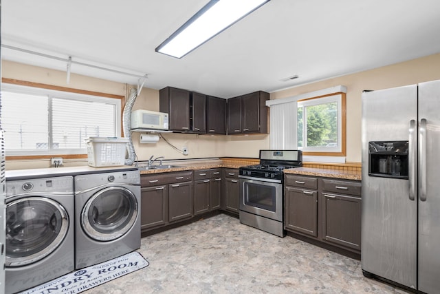 3850 Seaview Dr, Hanover Park, IL 60133 - kitchen featuring appliances with stainless steel finishes, washing machine and dryer, and dark brown cabinets