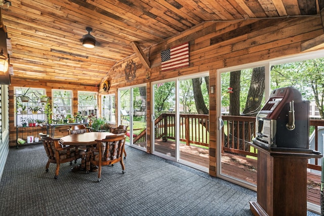 3850 Seaview Dr, Hanover Park, IL 60133 - sunroom featuring lofted ceiling, carpet flooring, a wooden deck, outdoor dining space, and wood walls