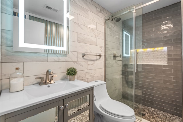 3850 Seaview Dr, Hanover Park, IL 60133 - bathroom with a shower stall, vanity, and tile walls