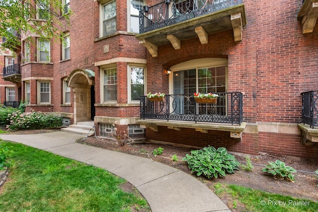 5323 S Harper Ave S Unit 1, Chicago, IL 60615 - view of exterior entry with brick siding and a balcony