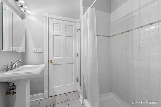 5323 S Harper Ave S Unit 1, Chicago, IL 60615 - bathroom with a stall shower and tile patterned floors
