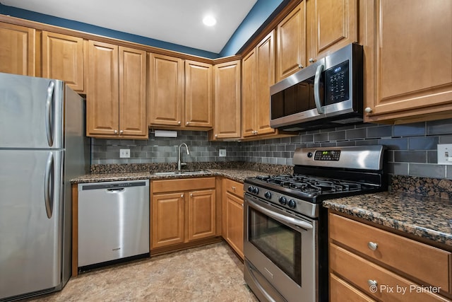 5323 S Harper Ave S Unit 1, Chicago, IL 60615 - kitchen featuring appliances with stainless steel finishes, backsplash, and dark stone counters