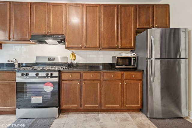 7639 Jackson Blvd Unit 1-W, Forest Park, IL 60130 - kitchen featuring stainless steel appliances, under cabinet range hood, tasteful backsplash, and brown cabinetry
