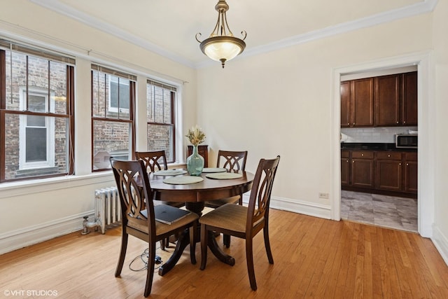 7639 Jackson Blvd Unit 1-W, Forest Park, IL 60130 - dining space with radiator heating unit, ornamental molding, and light wood-style floors