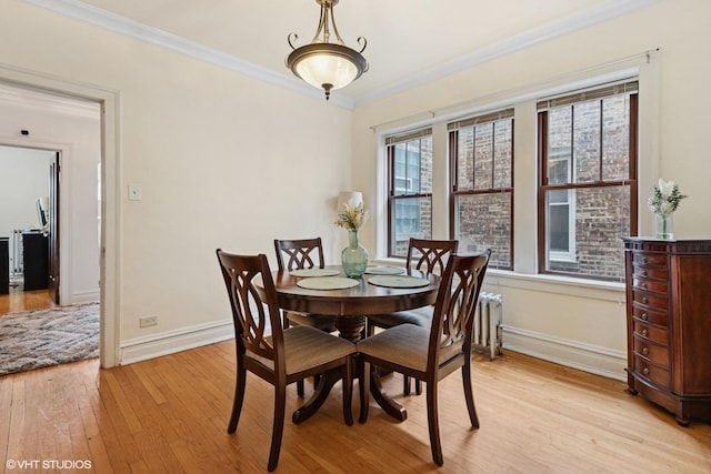 7639 Jackson Blvd Unit 1-W, Forest Park, IL 60130 - dining area featuring light wood-style floors, ornamental molding, and radiator heating unit