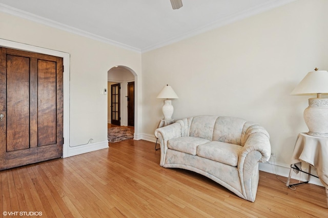 7639 Jackson Blvd Unit 1-W, Forest Park, IL 60130 - living area featuring arched walkways, light wood-style flooring, ornamental molding, and ceiling fan