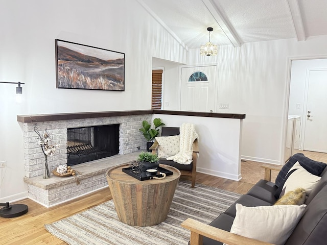 6412 Redbird Ln, Crystal Lake, IL 60012 - living room with wood finished floors, a fireplace, and a chandelier