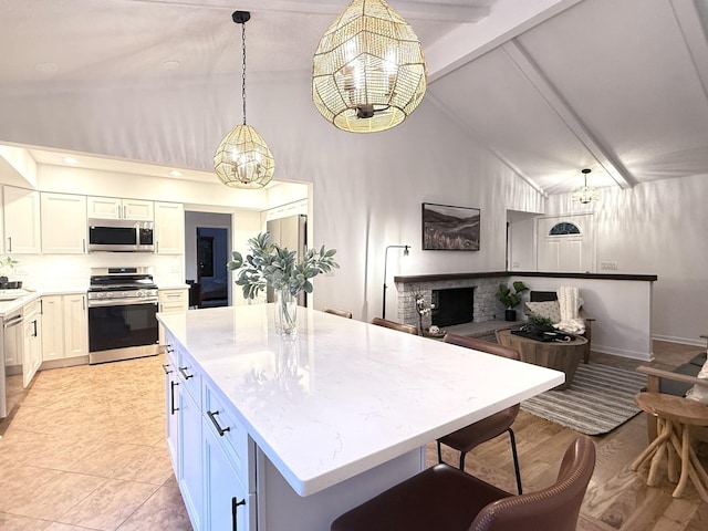 6412 Redbird Ln, Crystal Lake, IL 60012 - kitchen with appliances with stainless steel finishes, a chandelier, beam ceiling, a center island, and light stone countertops