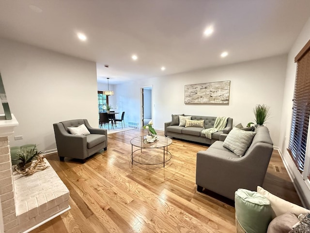 6412 Redbird Ln, Crystal Lake, IL 60012 - living room with light wood-type flooring, recessed lighting, a fireplace, and a chandelier