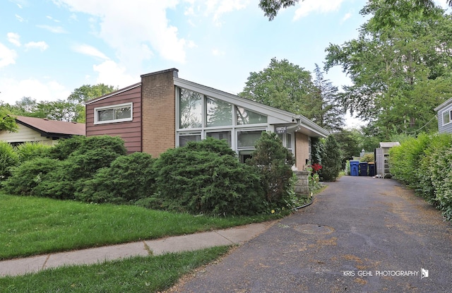1247 Cavell Ave, Highland Park, IL 60035 - view of side of property featuring driveway and brick siding
