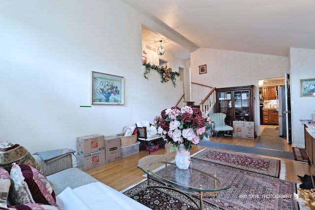 1247 Cavell Ave, Highland Park, IL 60035 - living room with lofted ceiling, light wood-style floors, stairway, and a chandelier