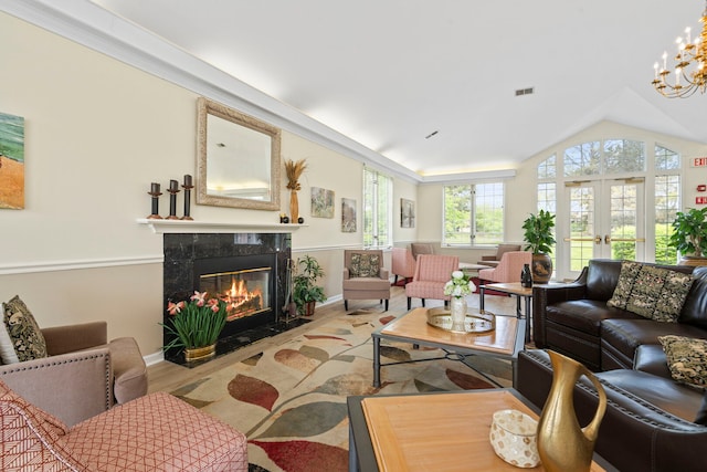 3100 Lexington Ln Unit 203, Glenview, IL 60026 - living area featuring a fireplace, vaulted ceiling, and a chandelier