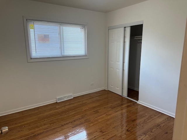 16341 Justine St, Markham, IL 60428 - unfurnished bedroom featuring dark wood-type flooring and a closet