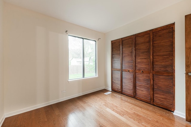 2322 Weatherford Ln, Naperville, IL 60565 - unfurnished bedroom with light wood finished floors and a closet