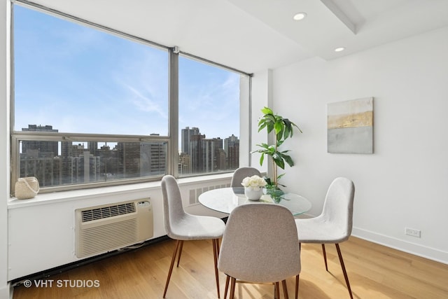 1455 N Sandburg Ter Unit 2606, Chicago, IL 60610 - dining room featuring wood finished floors, plenty of natural light, a wall mounted AC, recessed lighting, and a city view