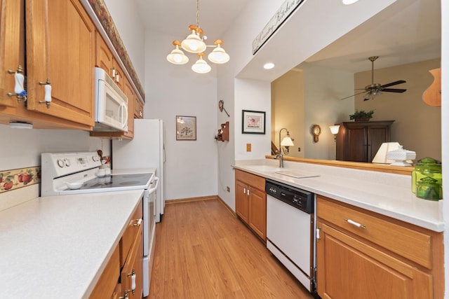 485 Raintree Ct Unit B, Glen Ellyn, IL 60137 - kitchen featuring white appliances, light countertops, light wood-style flooring, ceiling fan, and a chandelier