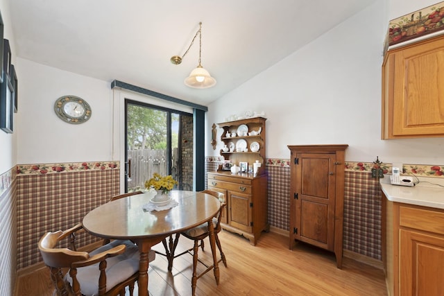 485 Raintree Ct Unit B, Glen Ellyn, IL 60137 - dining space featuring wainscoting, vaulted ceiling, light wood-style flooring, and tile walls