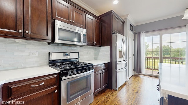 17958 Fountain Cir, Orland Park, IL 60467 - kitchen with appliances with stainless steel finishes, crown molding, light wood-style flooring, light countertops, and tasteful backsplash