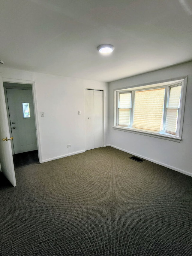3206 W Lydia Ave, Robbins, IL 60472 - unfurnished room with dark colored carpet and plenty of natural light