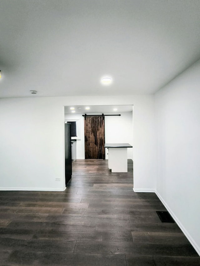 3206 W Lydia Ave, Robbins, IL 60472 - unfurnished room with a barn door, dark wood-style flooring, and recessed lighting