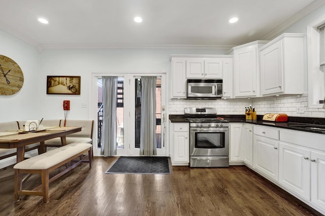 1428 W Lexington St Unit 1, Chicago, IL 60607 - kitchen featuring stainless steel appliances, crown molding, dark countertops, tasteful backsplash, and dark wood-style flooring